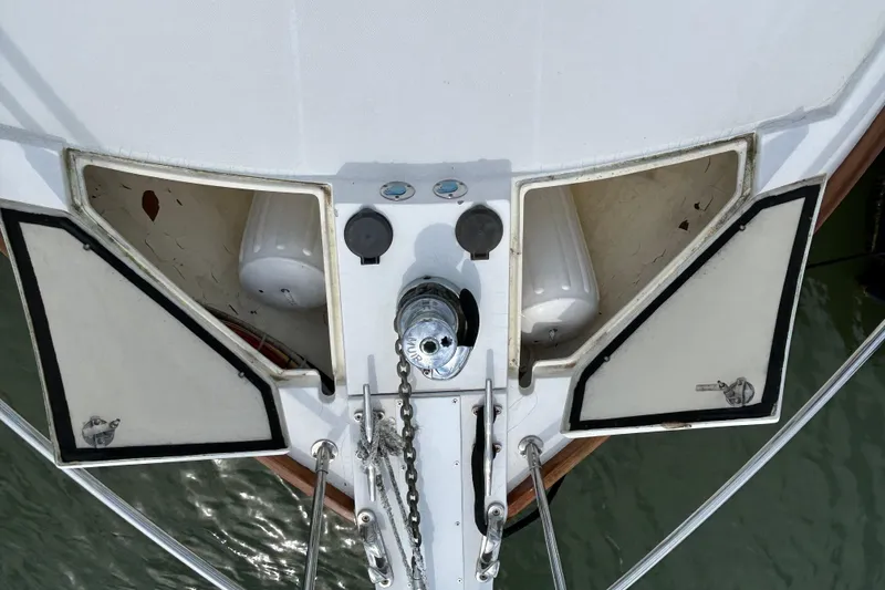 Slide: The Image of Bow view of 2004 Sabre 36 FB yacht with anchor chain and storage compartments. - 16