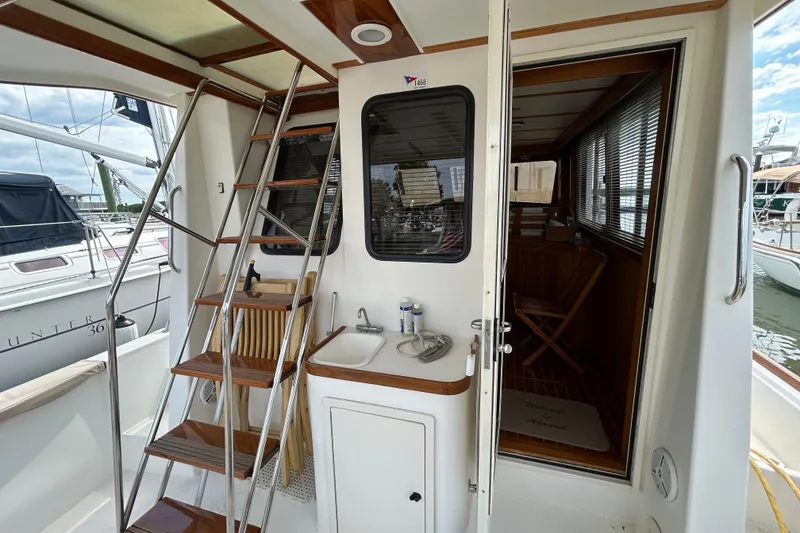 Slide: The Image of 2004 Sabre 36 FB yacht interior with ladder, sink, and wooden accents. - 17