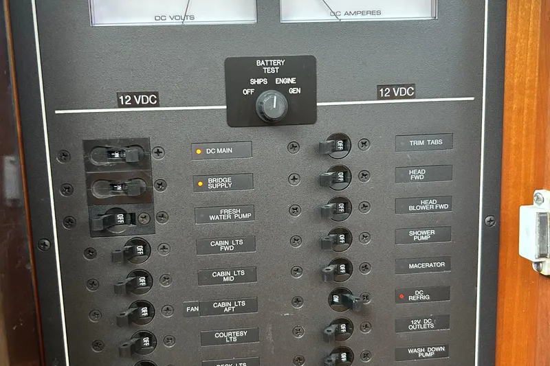 Slide: The Image of Electrical panel of a 2004 Sabre 36 FB boat, showing 12 VDC switches and controls. - 21