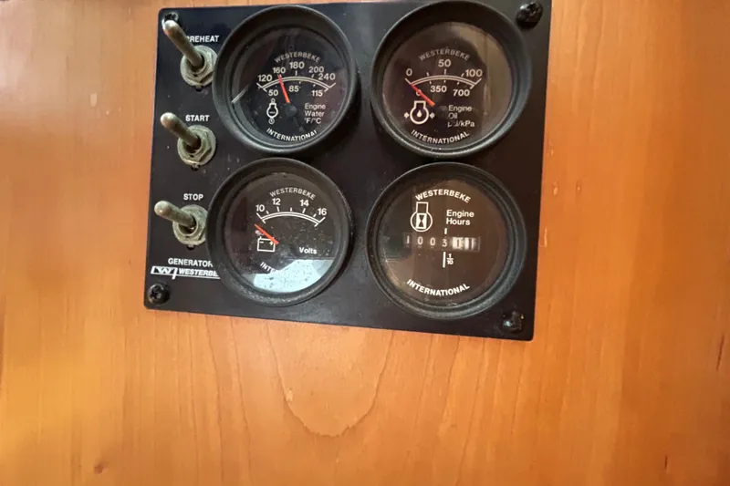Slide: The Image of Control panel of a 2004 Sabre 36 FB with Westerbeke gauges and switches. - 22