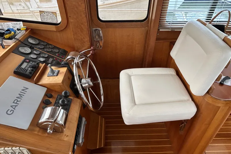 Slide: The Image of Helm of 2004 Sabre 36 FB yacht with Garmin navigation and white captain's chair. - 23