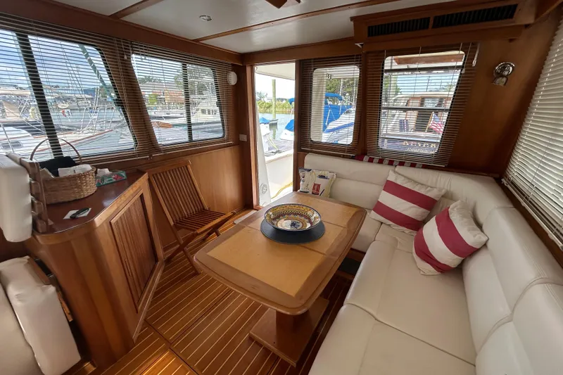 Slide: The Image of Luxurious 2004 Sabre 36 FB yacht interior with wooden accents and cozy seating area. - 26
