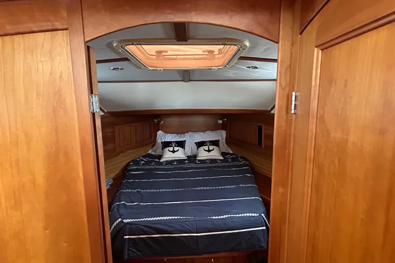 Slide: The Image of Cozy cabin interior of 2004 Sabre 36 FB yacht with nautical-themed bedding. - 32