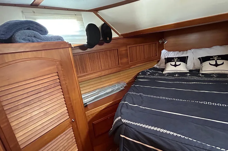 Slide: The Image of Cozy cabin interior of 2004 Sabre 36 FB yacht with nautical-themed bedding. - 33