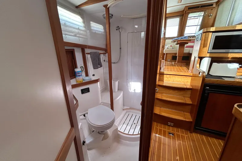Slide: The Image of Interior of 2004 Sabre 36 FB yacht showing bathroom and wooden stairs to cabin. - 38