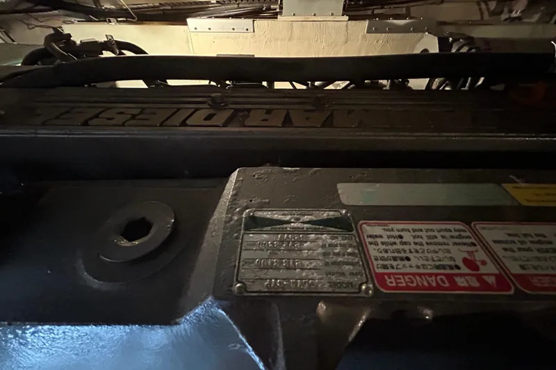 Slide: The Image of Engine compartment of a 2004 Sabre 36 FB boat, featuring a marine diesel engine. - 48