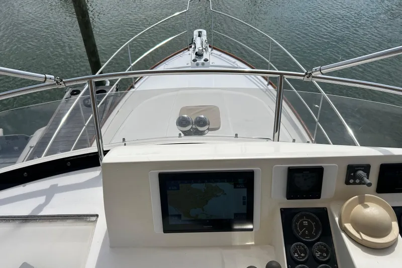 Slide: The Image of Helm view of 2004 Sabre 36 FB yacht with navigation equipment and water backdrop. - 9