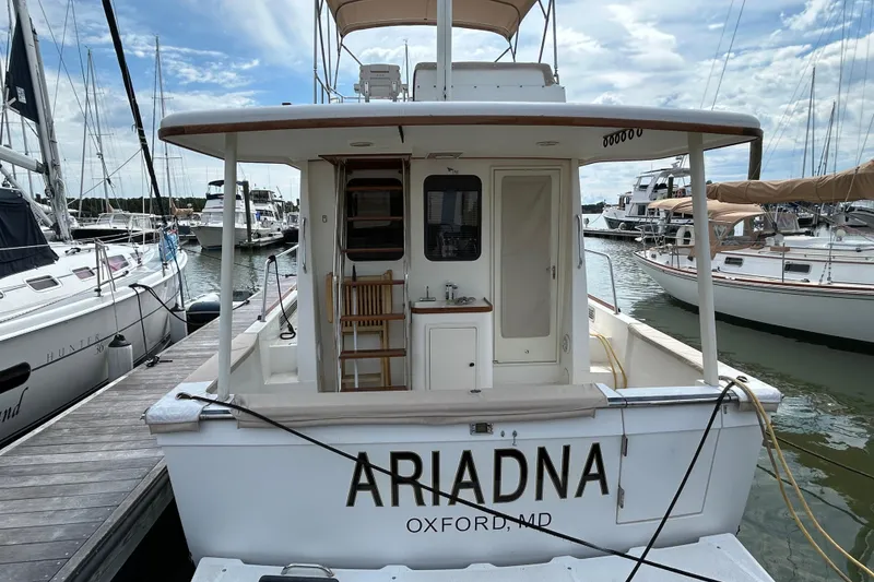 Slide: The Image of 2004 Sabre 36 FB boat named "Ariadna" docked at a marina in Oxford, MD. - 2