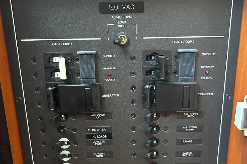 Slide: The Image of Electrical panel of a 2004 Sabre 36 FB boat, showing circuit breakers and switches. - 20