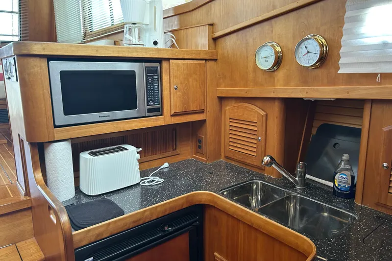 Slide: The Image of 2004 Sabre 36 FB yacht kitchen with microwave, toaster, and dual sink. - 29