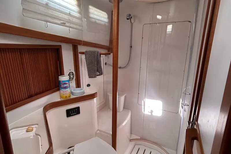Slide: The Image of Bathroom interior of 2004 Sabre 36 FB yacht, featuring shower and cleaning supplies. - 35