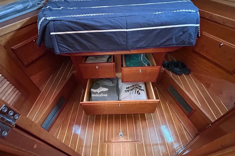 Slide: The Image of Interior of 2004 Sabre 36 FB boat with wooden flooring and storage drawers. - 36