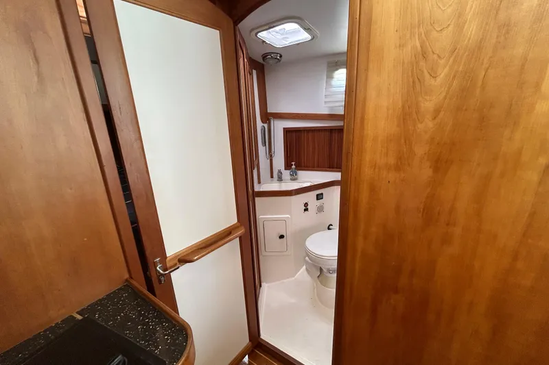 Slide: The Image of 2004 Sabre 36 FB yacht bathroom with wooden cabinetry and modern fixtures. - 39