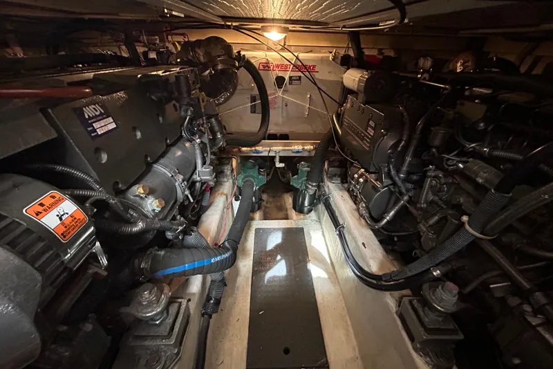 Slide: The Image of Engine room of 2004 Sabre 36 FB boat, featuring dual engines and mechanical components. - 44