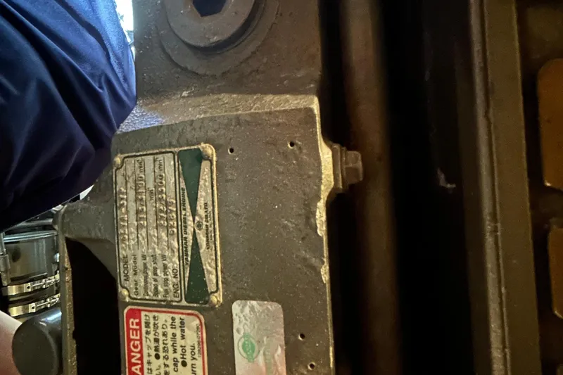 Slide: The Image of Close-up of a 2004 Sabre 36 FB engine component with warning labels. - 45