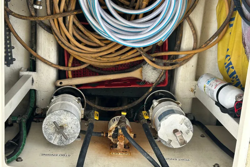 Slide: The Image of Engine compartment of 2004 Sabre 36 FB with hoses, fire extinguisher, and maintenance tools. - 46