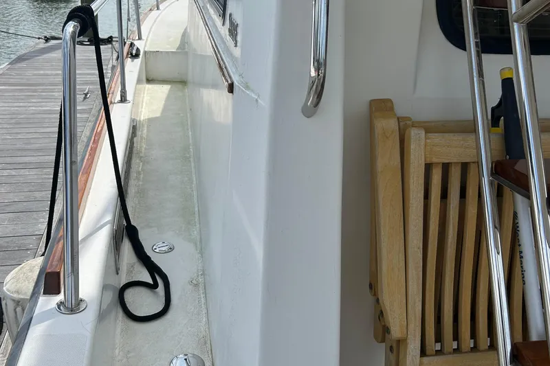 Slide: The Image of Side deck of 2004 Sabre 36 FB yacht with wooden chair and railing. - 6