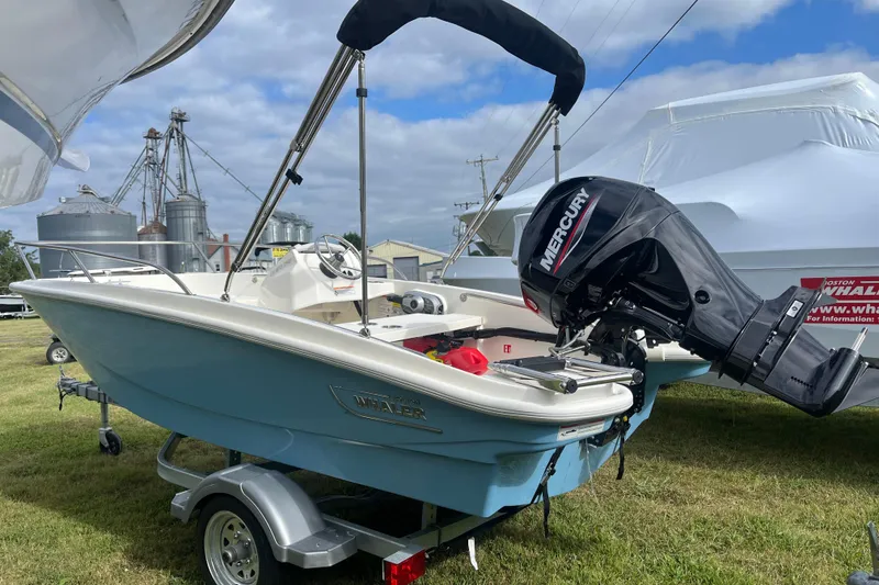 Slide: The Image of 2026 Boston Whaler 130 Super Sport boat with Mercury engine on trailer. - 18