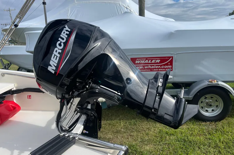 Slide: The Image of 2026 Boston Whaler 130 Super Sport with Mercury outboard motor on trailer. - 2