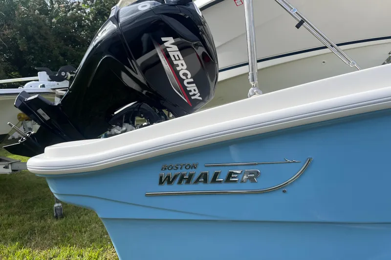 Slide: The Image of 2026 Boston Whaler 130 Super Sport boat with Mercury engine, side view. - 20