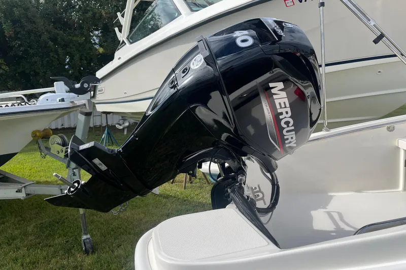 Slide: The Image of 2026 Boston Whaler 130 Super Sport with Mercury outboard motor on display. - 21