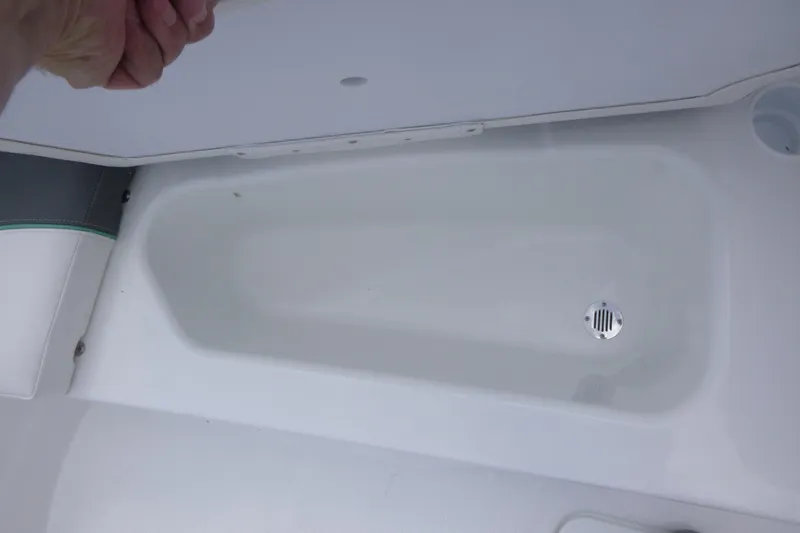 Slide: The Image of Storage compartment in 2026 Tahoe T16 boat with drain plug. - 10