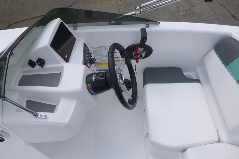 Slide: The Image of Interior view of 2026 Tahoe T16 boat cockpit with steering wheel and seating. - 12