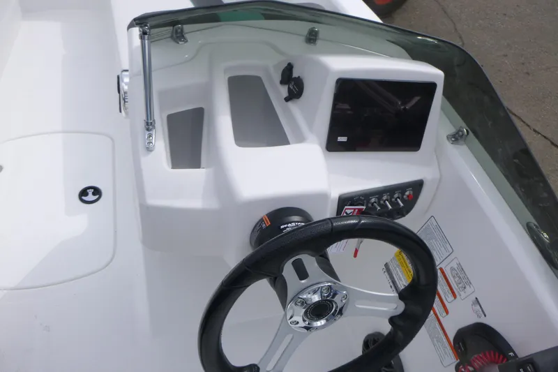 Slide: The Image of 2026 Tahoe T16 boat dashboard with steering wheel and control panel. - 13