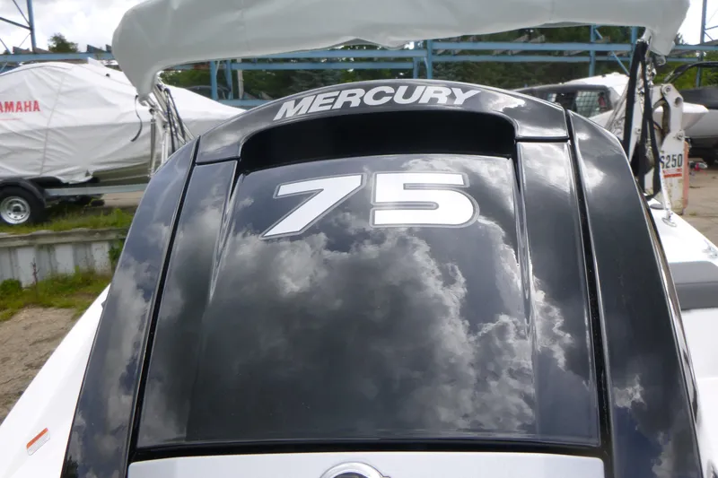 Slide: The Image of 2026 Tahoe T16 boat with Mercury 75 engine, reflecting cloudy sky. - 14