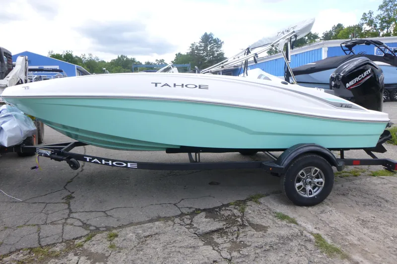 Slide: The Image of 2026 Tahoe T16 boat on trailer, mint green hull, parked outdoors. - 4