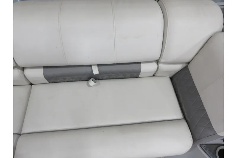 Slide: The Image of 2024 Sun Tracker Party Barge 24 DLX, white and gray cushioned seating detail. - 11