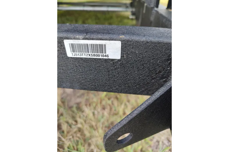 Slide: The Image of Close-up of a Sun Tracker Party Barge 24 DLX 2024 trailer with a visible barcode. - 13