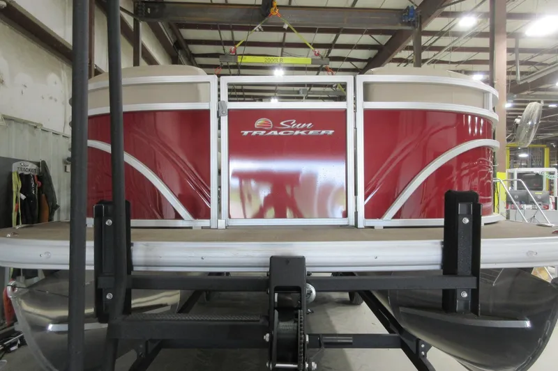Slide: The Image of 2024 Sun Tracker Party Barge 24 DLX pontoon boat in a warehouse setting. - 2