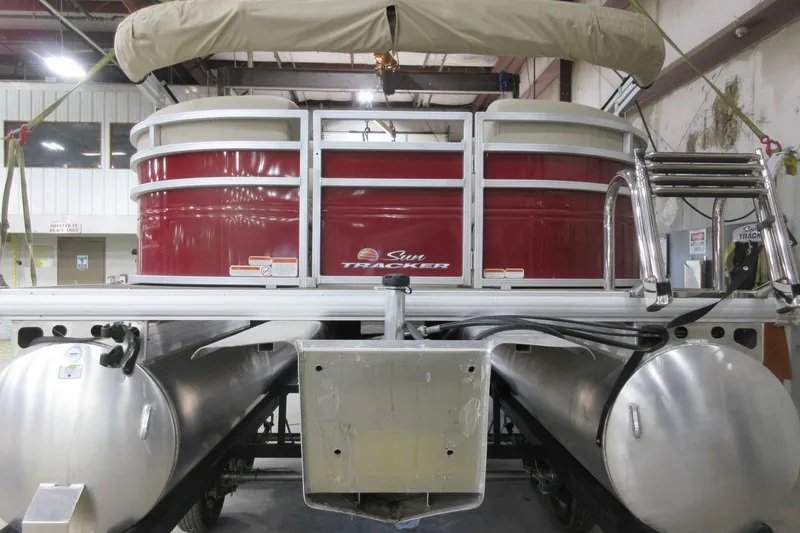 Slide: The Image of 2024 Sun Tracker Party Barge 24 DLX pontoon boat in a warehouse setting. - 3