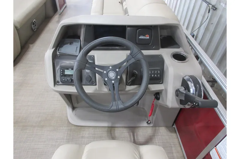 Slide: The Image of 2024 Sun Tracker Party Barge 24 DLX helm with steering wheel and controls. - 8