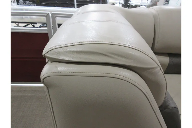 Slide: The Image of 2024 Sun Tracker Party Barge 24 DLX, beige leather seating detail. - 9