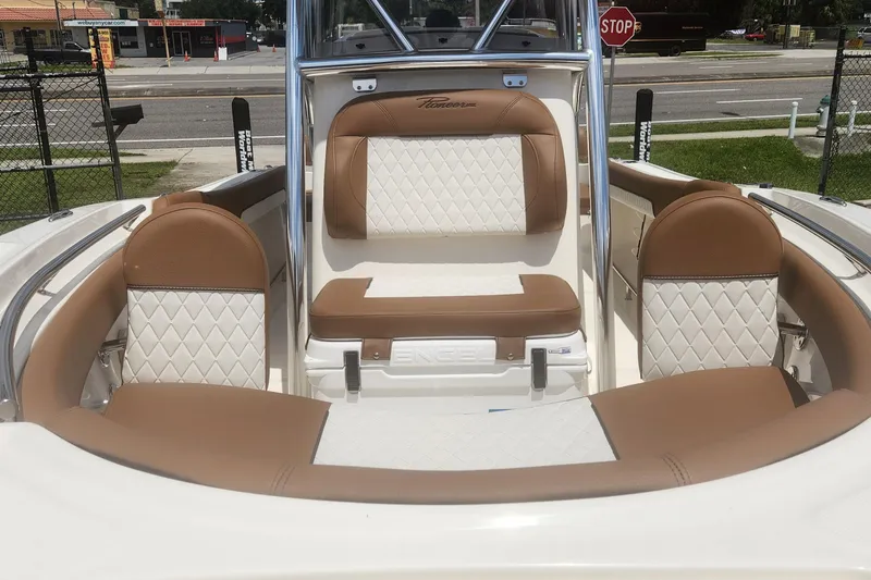 Slide: The Image of 2026 Pioneer 202 Sportfish boat interior with tan and white cushioned seating. - 10