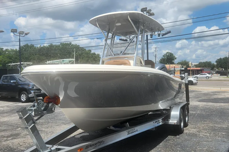 Slide: The Image of 2026 Pioneer 202 Sportfish boat on trailer under clear sky. - 11