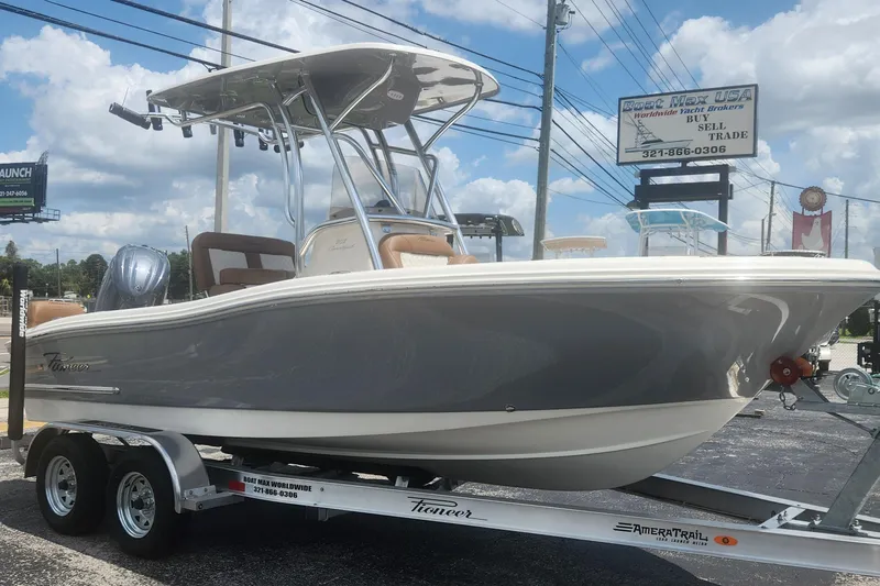 Slide: The Image of 2026 Pioneer 202 Sportfish boat on trailer, displayed outdoors under a cloudy sky. - 12