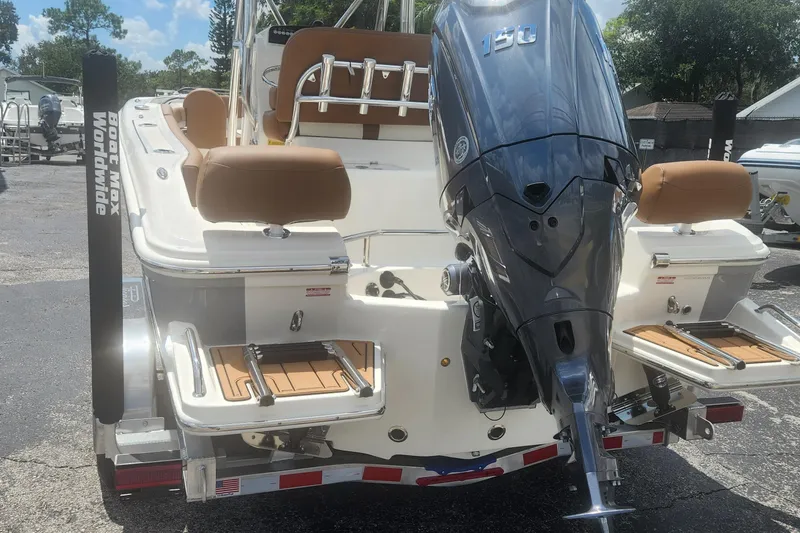 Slide: The Image of 2026 Pioneer 202 Sportfish boat with powerful outboard motor, parked on a trailer. - 3