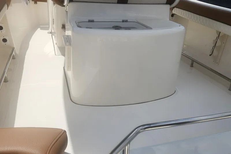 Slide: The Image of 2026 Pioneer 202 Sportfish boat interior with seating and storage area. - 5