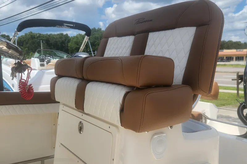 Slide: The Image of 2026 Pioneer 202 Sportfish boat seat with brown and white upholstery, outdoors. - 7