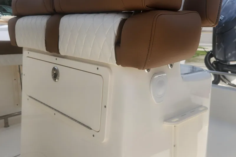 Slide: The Image of 2026 Pioneer 202 Sportfish boat seat with brown and white upholstery. - 8