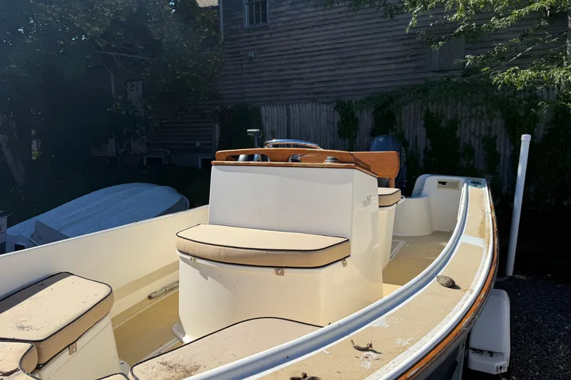Slide: The Image of 2003 Roth Bilt 16 Skiff boat with cushioned seating and wooden steering console. - 3