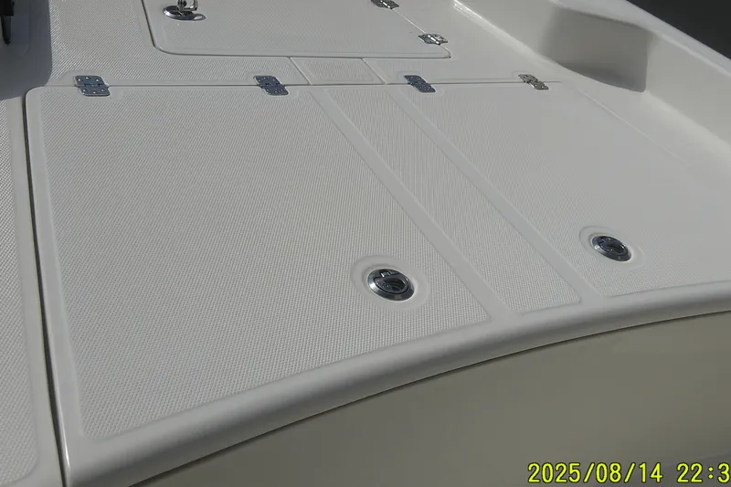 Slide: The Image of 2024 Mako Pro Skiff 15 CC deck with storage hatches and stainless steel fittings. - 10