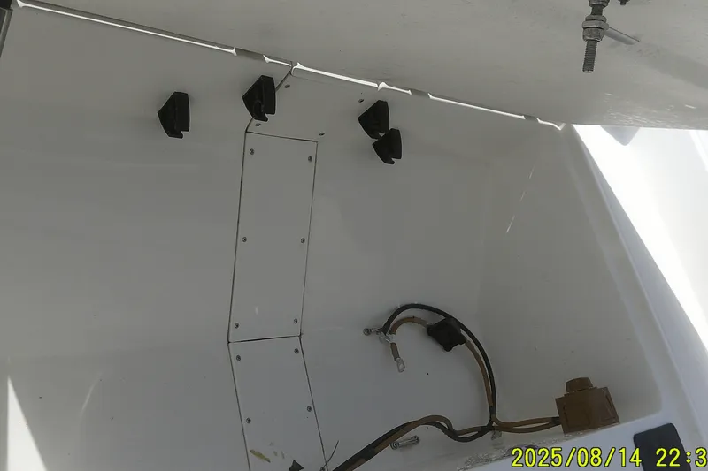Slide: The Image of Interior view of a 2024 Mako Pro Skiff 15 CC boat compartment with wiring. - 11