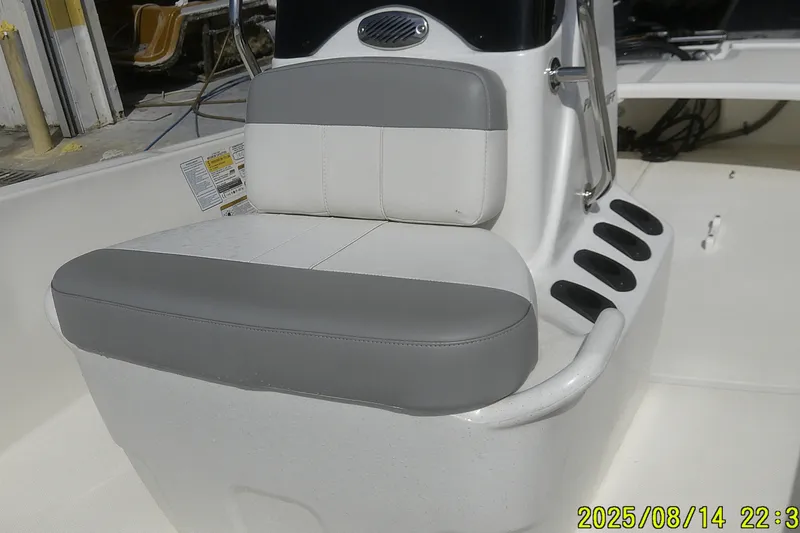 Slide: The Image of 2024 Mako Pro Skiff 15 CC boat interior with gray and white seating. - 12