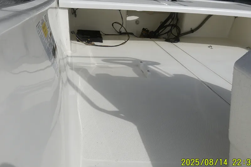 Slide: The Image of 2024 Mako Pro Skiff 15 CC interior, showcasing clean deck and wiring details. - 15
