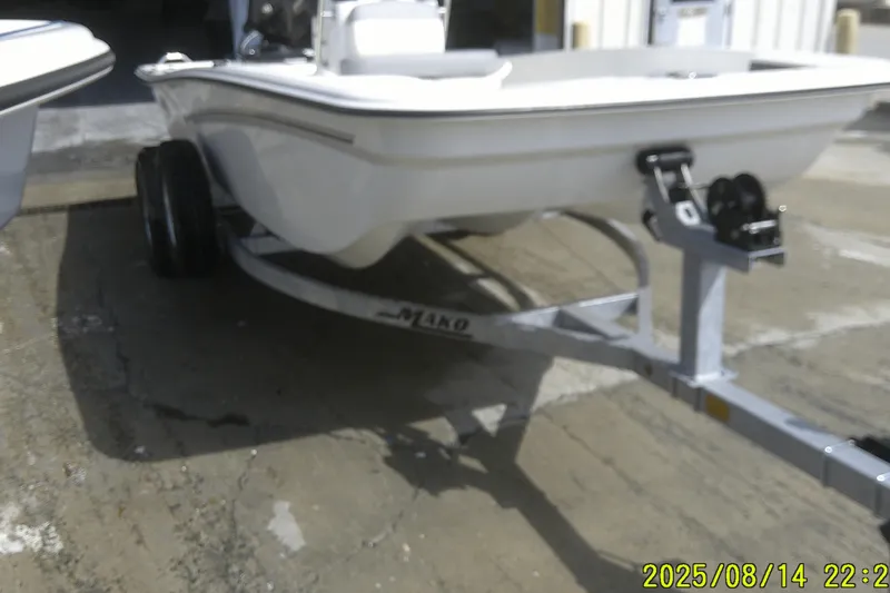 Slide: The Image of 2024 Mako Pro Skiff 15 CC on trailer, parked outdoors. - 5