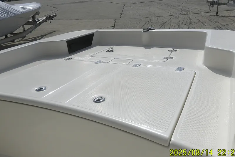 Slide: The Image of 2024 Mako Pro Skiff 15 CC boat deck, featuring storage compartments and sleek design. - 6